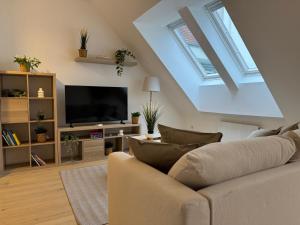 a living room with a couch and a flat screen tv at Modern Apartment in Döbling in Vienna