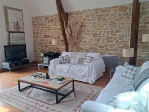 a living room with a couch and a coffee table at La Source de Diège in Loupiac