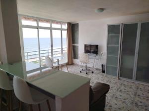a living room with a view of the ocean at Campello Muchavista Beach in El Campello