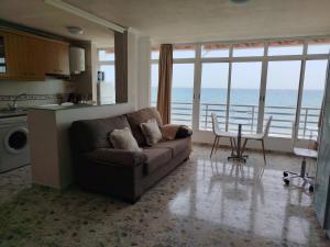 a living room with a couch and a table at Campello Muchavista Beach in El Campello