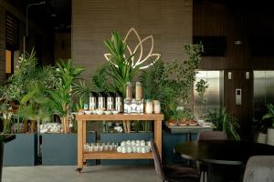 a table with bottles of wine and plants at Uukam by Bernalo Hotels in Medellín