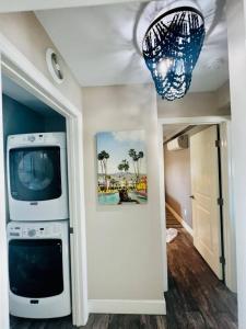 a living room with a television and a chandelier at Wake up 2 Quiet Ocean Views, centrally located A1A in Ormond Beach