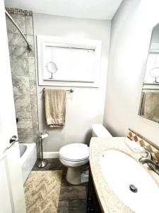 a bathroom with a toilet and a sink and a shower at Wake up 2 Quiet Ocean Views, centrally located A1A in Ormond Beach +28 photos