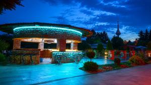 a circular building with a tower in the background at Hipodruma Resort & Pool in Dobrich