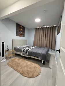 a bedroom with a bed and a rug at Entire 2BR Suite 12 min to Airport in Calgary
