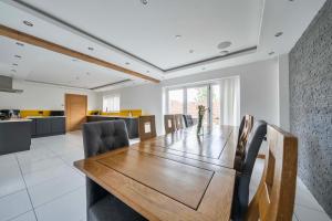 a dining room with a wooden table and chairs at Modern Large 4-Bed Property sleeps 10 in Abergele in Abergele