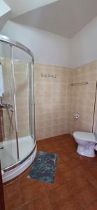 a bathroom with a shower and a toilet at Kapitan Hook in Mielno +57 photos