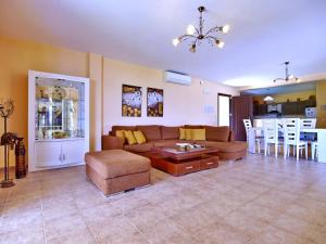 a living room with a couch and a table at Villa Alexandros in Spartià