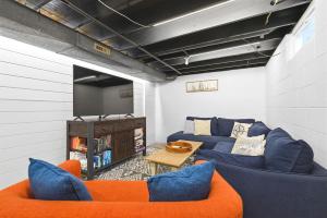 a living room with two blue couches and a tv at La Maison du Lac in Sawyer