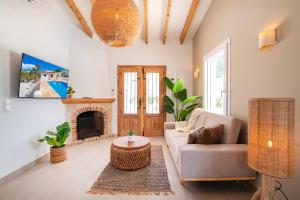 a living room with a couch and a fireplace at Villa Mawaki Calpe in Calpe