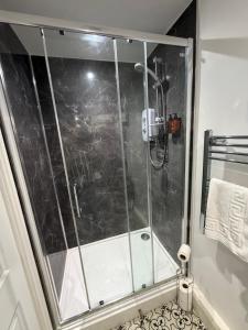 a shower with a glass door in a bathroom at Bolton arms downholme in Richmond