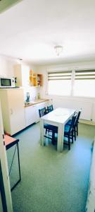 a room with a table and chairs in a kitchen at Evasion Gérardmer in Gérardmer +17 photos
