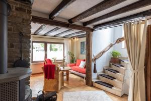 a living room with a staircase and a red couch at Ferienhaus Rosa in Mechernich