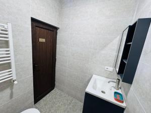 a bathroom with a sink and a toilet at Due apartments in Borjomi +14 photos