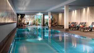 a swimming pool with blue water in a house at AMERON Davos Swiss Mountain Resort in Davos
