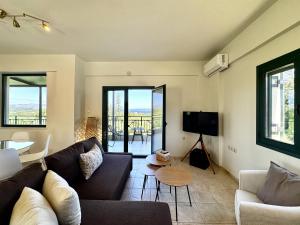 a living room with a couch and a table at Villa Nynemia Almyrida Crete in Plaka