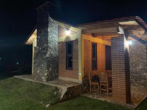 a small brick house with a porch at night at Zidada Mundo Magico in Huasca de Ocampo