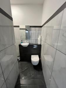 a small bathroom with a toilet and a sink at Cosy flat in central Cardiff Bay in Cardiff