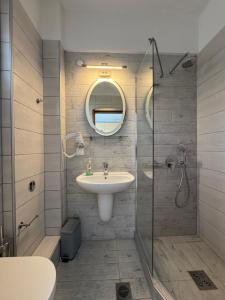 a bathroom with a sink and a shower at Barbara House in Kriopigi