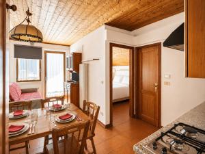 a kitchen and dining room with a table and chairs at Residence Borgo Al Sole in Sappada +39 photos