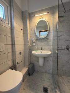 a bathroom with a sink and a mirror at Barbara House in Kriopigi +23 photos