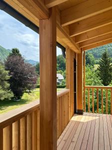 a wooden porch with a view of the mountains at Haus der Achtsamkeit in Grünau im Almtal +16 photos