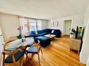 a living room with a blue couch and a table at Inn on Willard in South Portland
