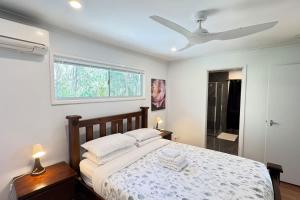 a bedroom with a bed and a ceiling fan at Pool house in Marsden