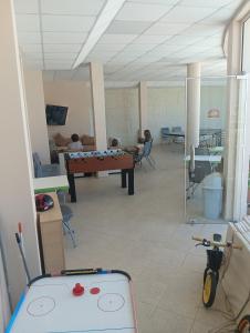 a room with a ping pong table and people in the background at Sun Village House 14 in Byala +21 photos