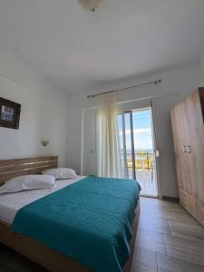 a bedroom with a bed and a large window at Barbara House in Kriopigi