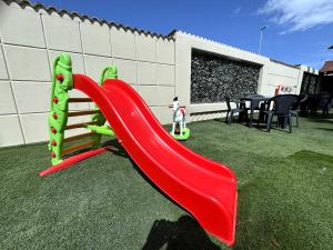 a playground with a slide in a yard at Le Tre Rose di Metta in Cerignola