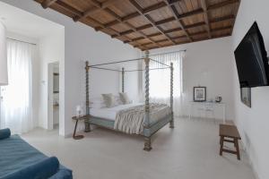 a bedroom with a canopy bed and a tv at Villa Tuzzo in Lecce +82 photos
