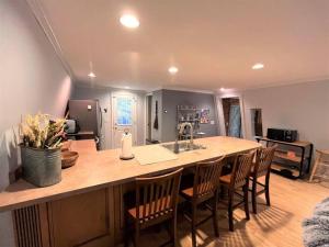 a kitchen with a large kitchen island with chairs at Ahmeek-5 in Dover