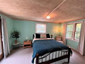 a bedroom with a bed and two windows at Ahmeek-5 in Dover