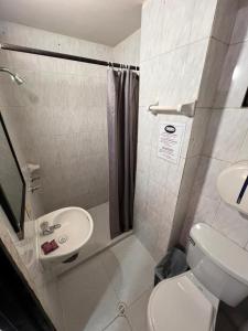 a small bathroom with a toilet and a sink at Hotel San Juan 70 Express Medellin in Medellín +48 photos