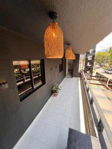 a building with two pendant lights and a patio at Hotel San Juan 70 Express Medellin in Medellín