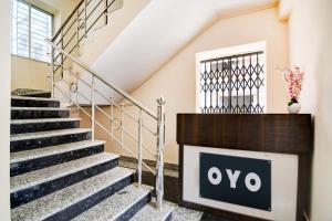a sign on the side of a stairs in a building at Hotel O by OYO Eco Greenway Retreat in Salua