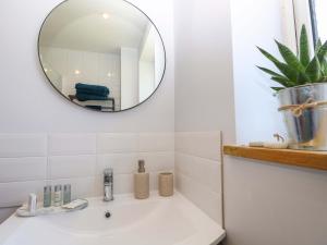 a bathroom with a sink and a mirror at Camellia Cottage in Wimborne Minster +33 photos