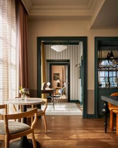 a living room with a table and chairs at Cincinnati's Fidelity Hotel in Cincinnati