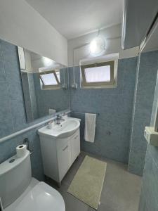 a bathroom with a toilet and a sink and a mirror at Casa C&S in Mascali +58 photos
