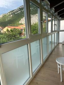a room with windows with a view of a mountain at Valentinas retreat in San Dorligo della Valle