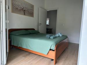 a bedroom with a bed with green sheets and blue pillows at Valentinas retreat in San Dorligo della Valle