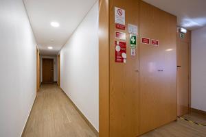 a hallway of an office building with a elevator at Central Suítes 3 in São João da Madeira