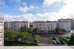 a view of a parking lot in a city with buildings at Central Suítes 3 in São João da Madeira +37 photos