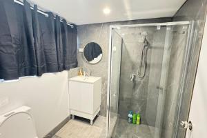 a bathroom with a shower and a toilet at Pool house for BIG Groups with Free parking in Marsden +22 photos