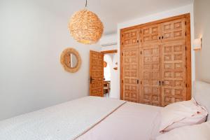 a bedroom with a bed and a wooden door at Villa Mawaki Calpe in Calpe +16 photos