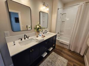 a bathroom with a sink and a large mirror at Nest in the City in Fort Mill +12 photos