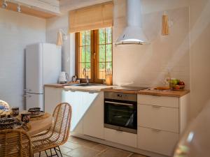 a kitchen with a white refrigerator and a table at Bugiem i Miodem in Siemiatycze
