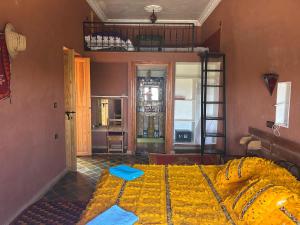 a bedroom with a bed in a room at Kasbah Petit Nomade in Tinerhir