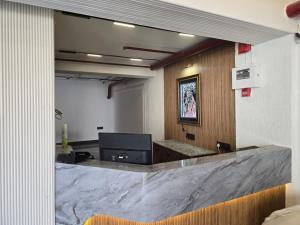 a room with a large marble counter in a building at Shree Radha Raman Sarkar Dham in Vrindāvan